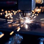 CNC Laser cutting of metal close up, modern industrial technology. Small depth of field.